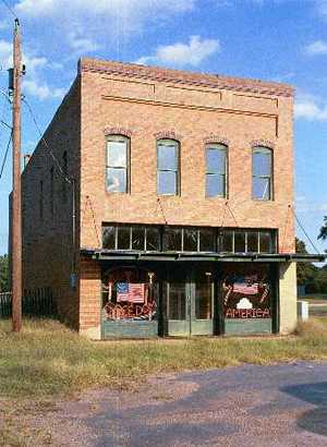 Store with flag on window, Golden, Texas