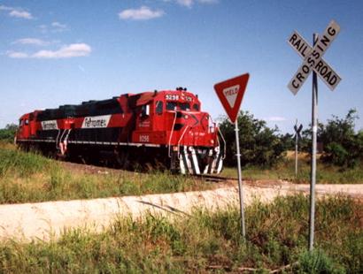 Diesel locomotive near Rail Road Yield Sign