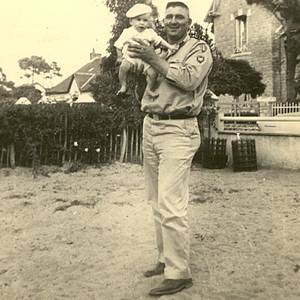 Military man holding baby