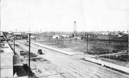 Isom TX main street and oil derrick, 1926