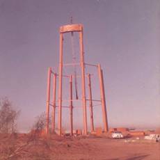 Water tower construction using basket pole crane